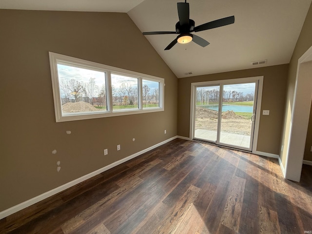 empty room featuring ceiling fan, lofted ceiling, and dark hardwood / wood-style floors