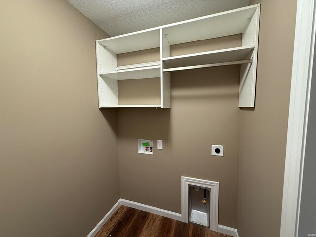 laundry room with hookup for an electric dryer, dark hardwood / wood-style flooring, hookup for a washing machine, and a textured ceiling