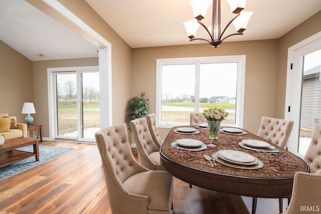 dining room with a chandelier and light wood-style flooring