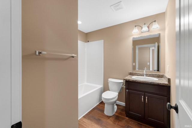 full bathroom with vanity, hardwood / wood-style flooring, bathtub / shower combination, and toilet