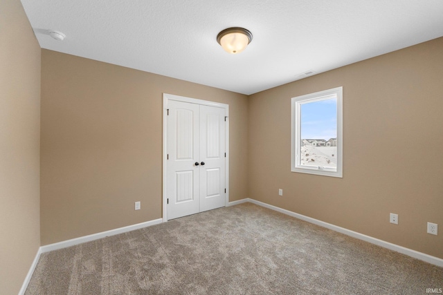 unfurnished bedroom with a closet and carpet