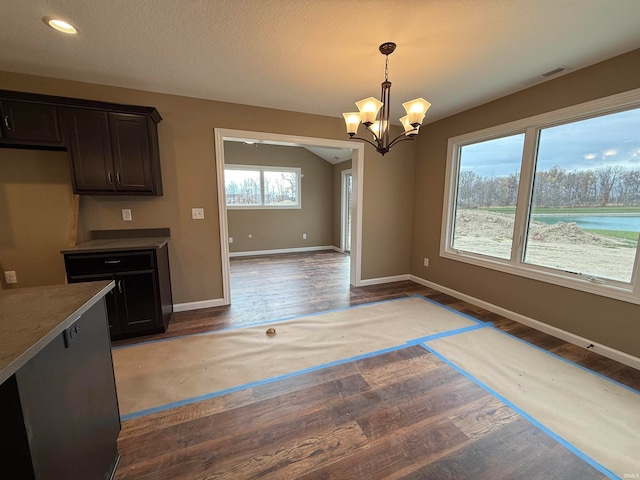 kitchen with hardwood / wood-style flooring, decorative light fixtures, dark brown cabinets, and a notable chandelier