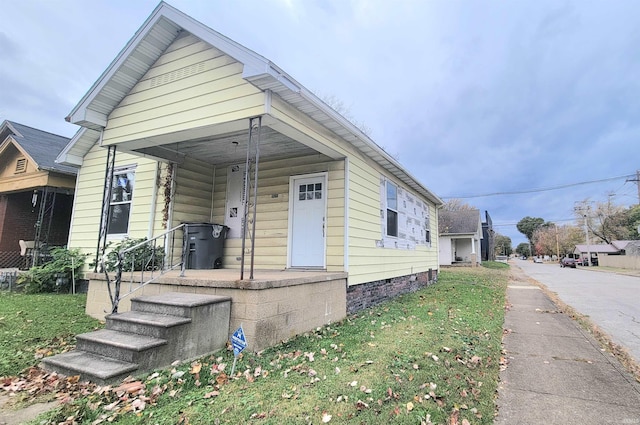 bungalow-style house featuring a front yard