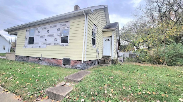 view of side of home featuring a lawn