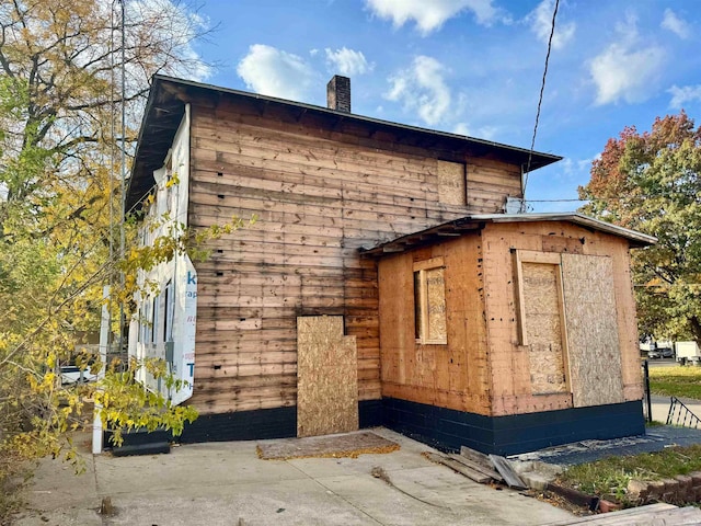 view of property exterior featuring a storage shed and a patio area