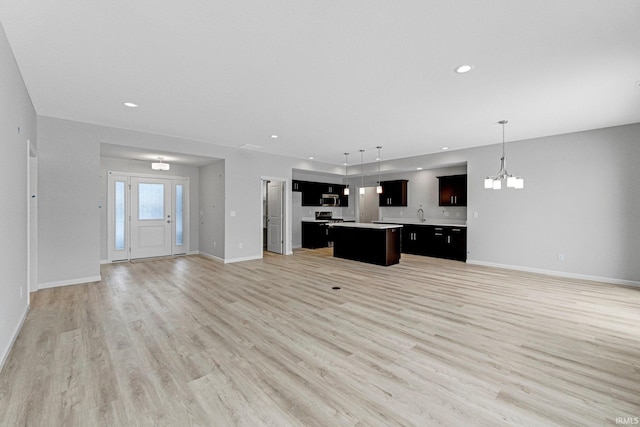 1333 Zenos Blvd, Fort Wayne, IN 46818 - unfurnished living room with a chandelier, light wood-style flooring, baseboards, and recessed lighting