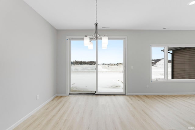 1333 Zenos Blvd, Fort Wayne, IN 46818 - unfurnished dining area with a chandelier, wood finished floors, and plenty of natural light