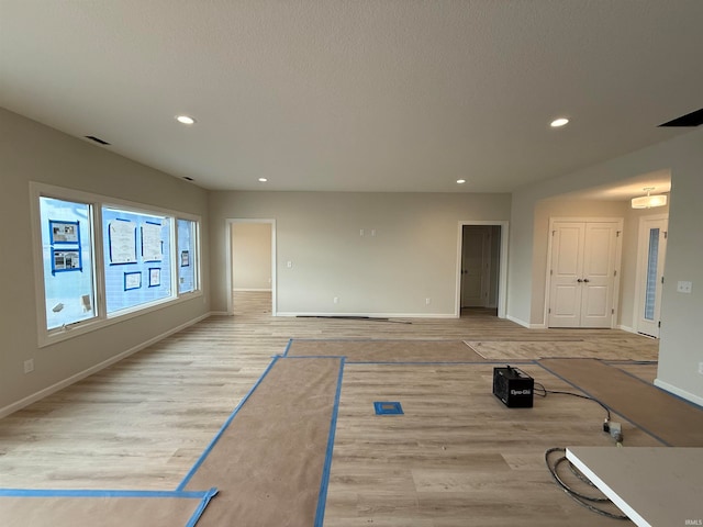 interior space with a textured ceiling and light wood-type flooring