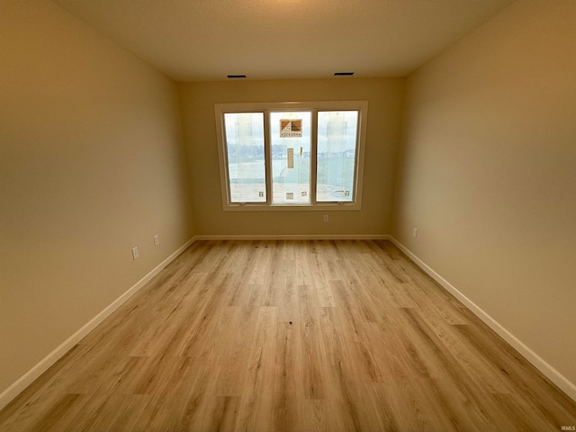 unfurnished room featuring light hardwood / wood-style floors