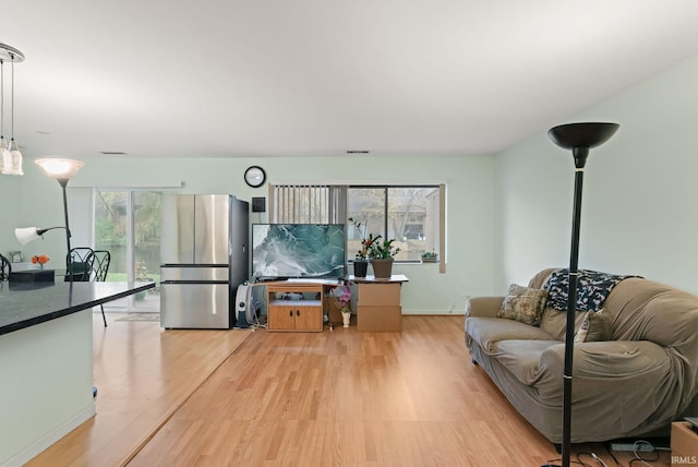 living room featuring light hardwood / wood-style floors and plenty of natural light