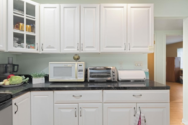 kitchen featuring white cabinets and wood-type flooring