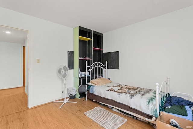 bedroom with hardwood / wood-style floors