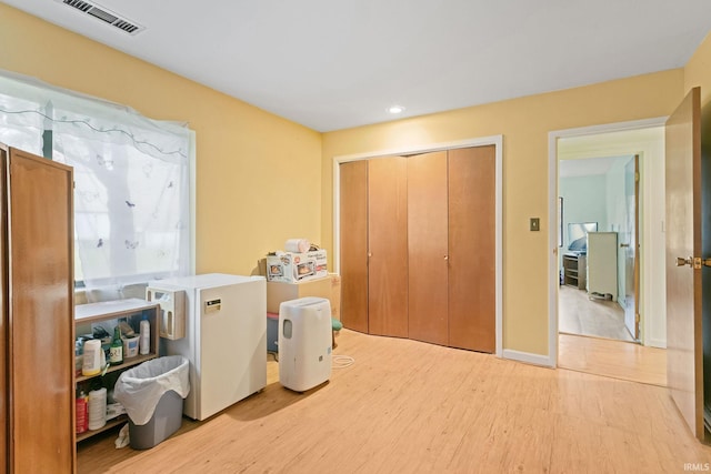 laundry area with light wood-type flooring