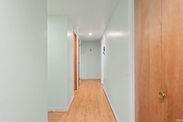 corridor with light hardwood / wood-style flooring