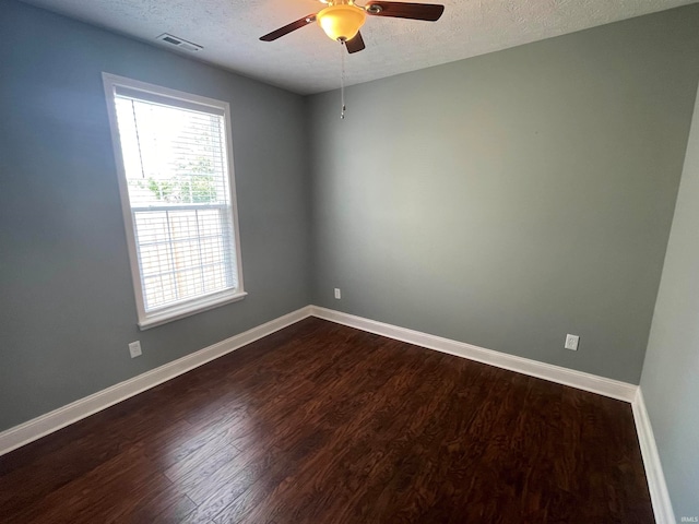 unfurnished room featuring dark hardwood / wood-style flooring, a textured ceiling, and ceiling fan