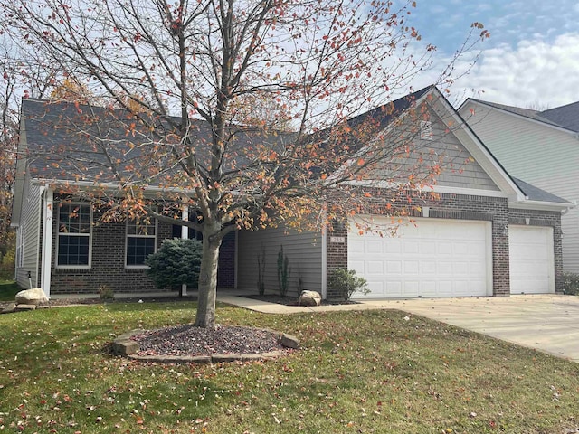 view of front of property featuring a garage and a front lawn