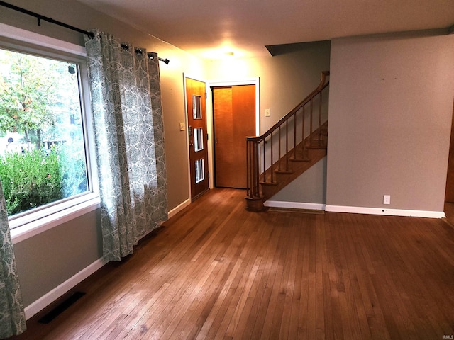 interior space with a barn door and hardwood / wood-style floors