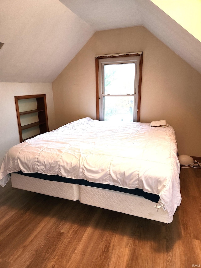 bedroom featuring lofted ceiling and dark wood-type flooring