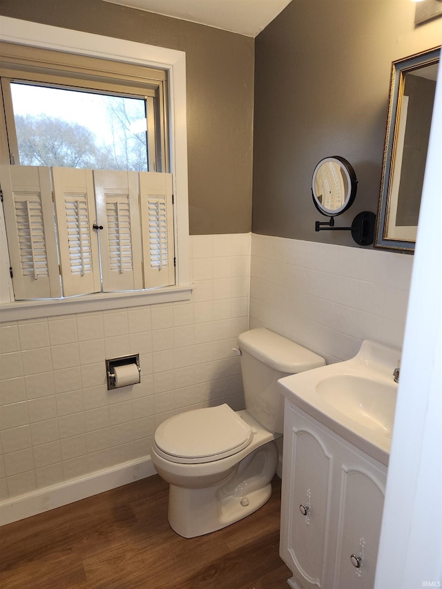 bathroom featuring hardwood / wood-style floors, vanity, toilet, and tile walls