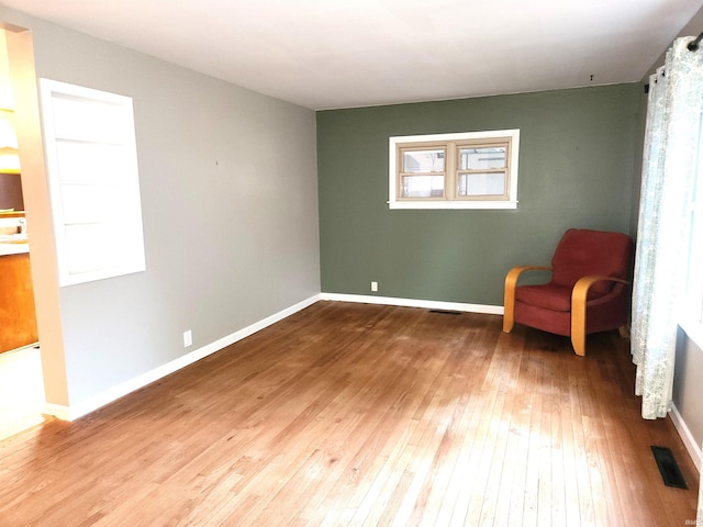 sitting room featuring hardwood / wood-style floors and plenty of natural light