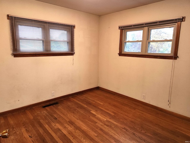 spare room with dark hardwood / wood-style floors