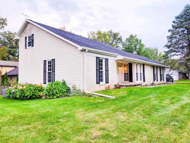 view of front facade featuring a front lawn and a patio area