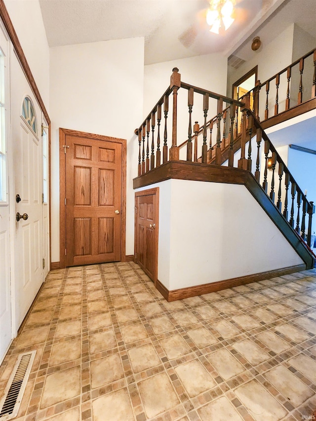 foyer featuring high vaulted ceiling