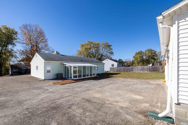 rear view of house featuring a patio area and a sunroom