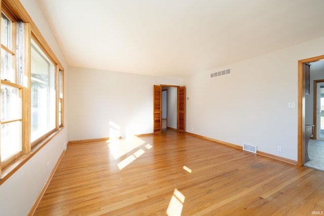 spare room with light wood-type flooring