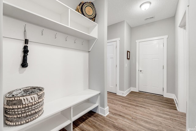 mudroom featuring hardwood / wood-style floors and a textured ceiling