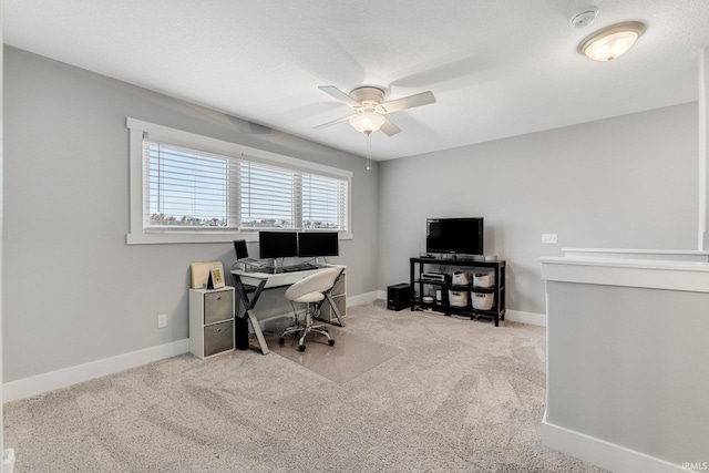 carpeted office featuring a textured ceiling and ceiling fan