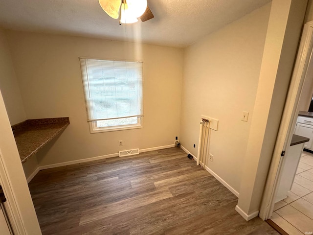 laundry room featuring washer hookup, hardwood / wood-style floors, and ceiling fan