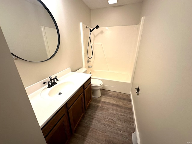 full bathroom featuring hardwood / wood-style flooring, shower / tub combination, vanity, and toilet