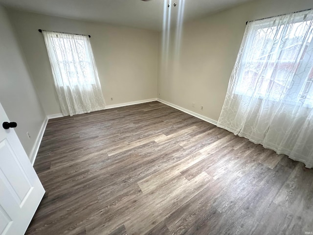 empty room with dark hardwood / wood-style flooring