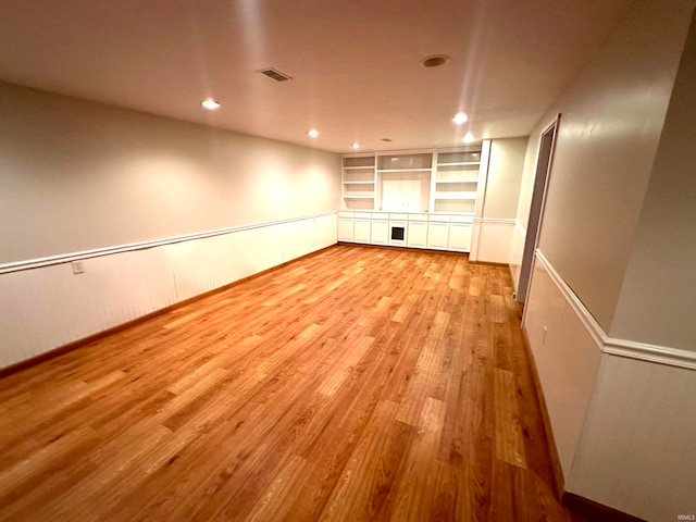 interior space featuring built in features and light hardwood / wood-style flooring