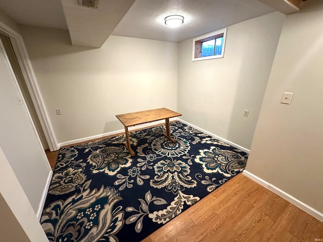 interior space featuring hardwood / wood-style flooring and a textured ceiling