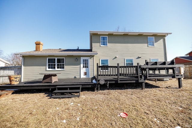 rear view of property featuring a wooden deck