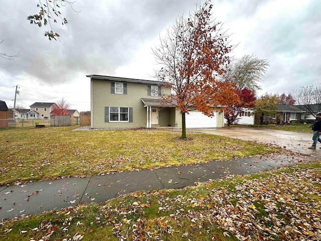 view of front of property featuring a garage and a front lawn