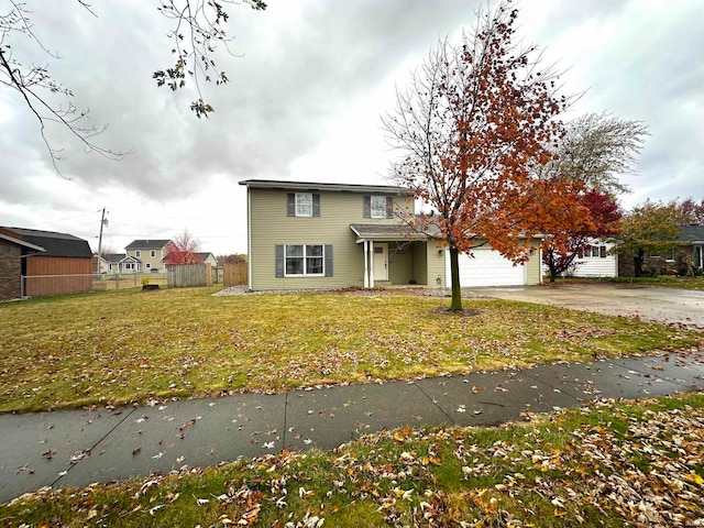 view of front of property with a garage and a front yard