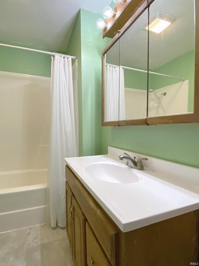 bathroom featuring vanity, shower / bath combo with shower curtain, and tile patterned floors