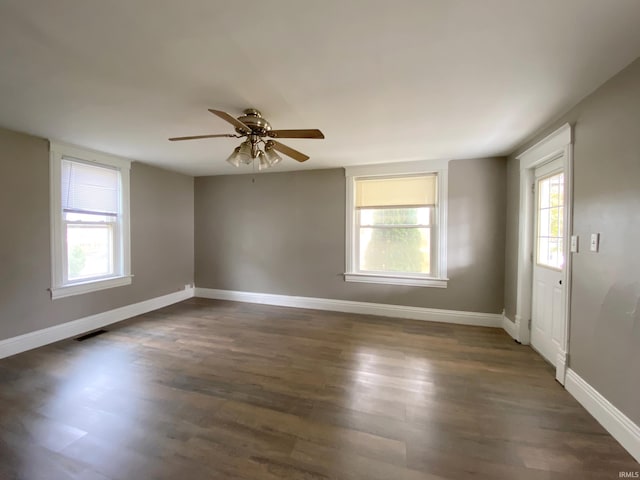 spare room with dark hardwood / wood-style floors and ceiling fan