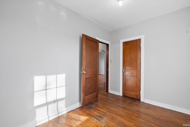 spare room with dark hardwood / wood-style flooring