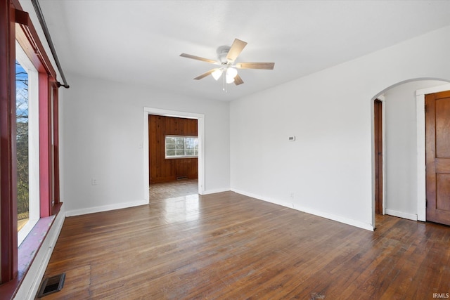 spare room featuring ceiling fan and dark hardwood / wood-style floors