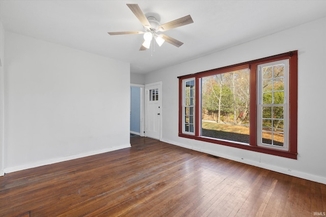 unfurnished room featuring dark hardwood / wood-style floors and ceiling fan