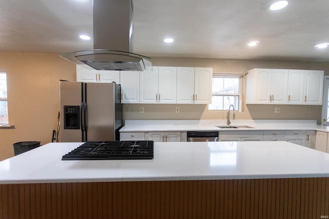 kitchen with white cabinets, stainless steel appliances, sink, and island exhaust hood