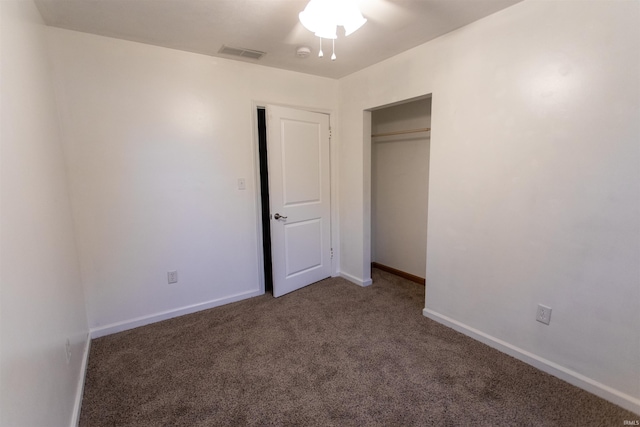 unfurnished bedroom featuring carpet floors and a closet