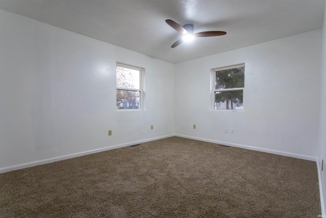 unfurnished room featuring ceiling fan and carpet flooring