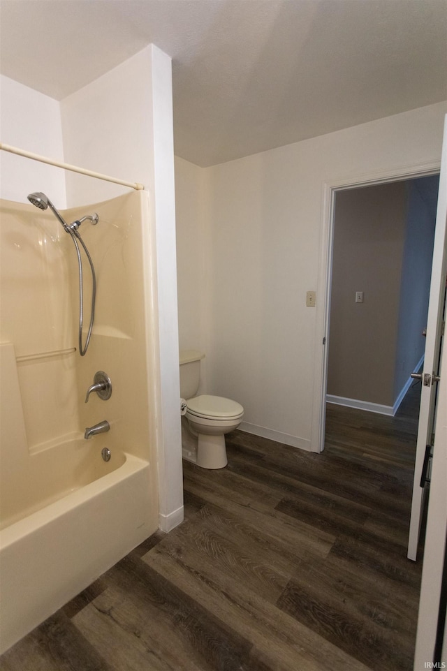 bathroom with toilet, shower / bath combination, and hardwood / wood-style floors