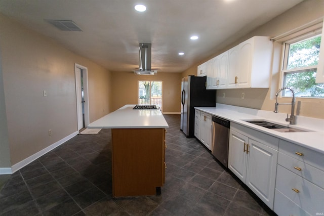 kitchen featuring white cabinetry, stainless steel appliances, sink, and a center island