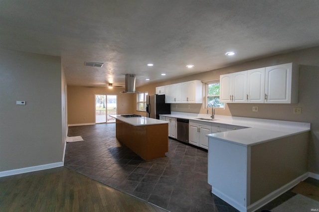 kitchen featuring stainless steel appliances, a wealth of natural light, white cabinetry, and a center island